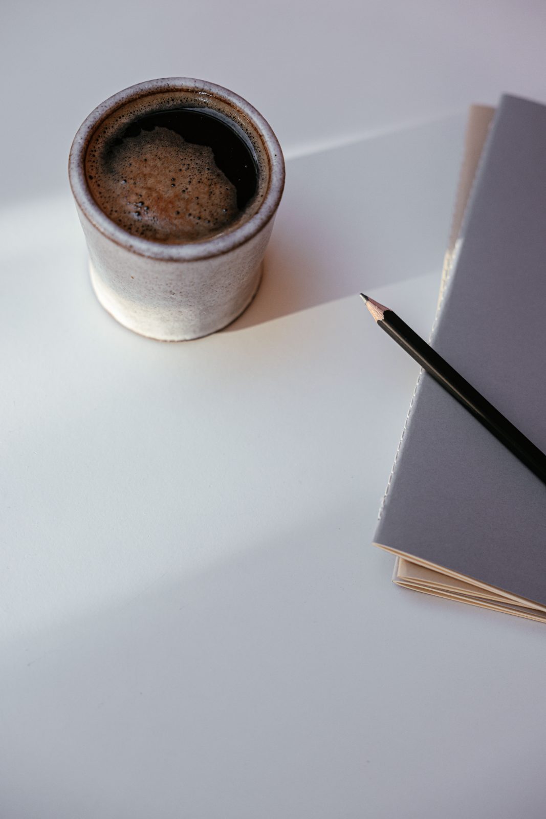 A cup beside an open notebook